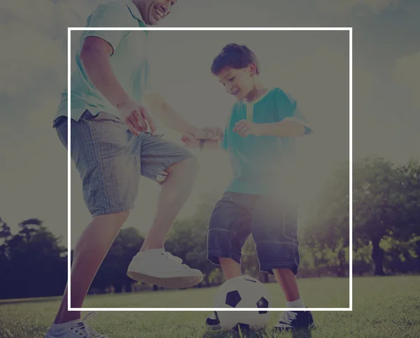 Father playing football with little son — Stockfoto