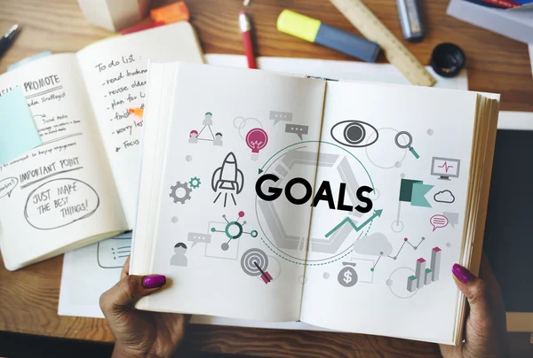 Woman holding book with goals — Stock Photo, Image