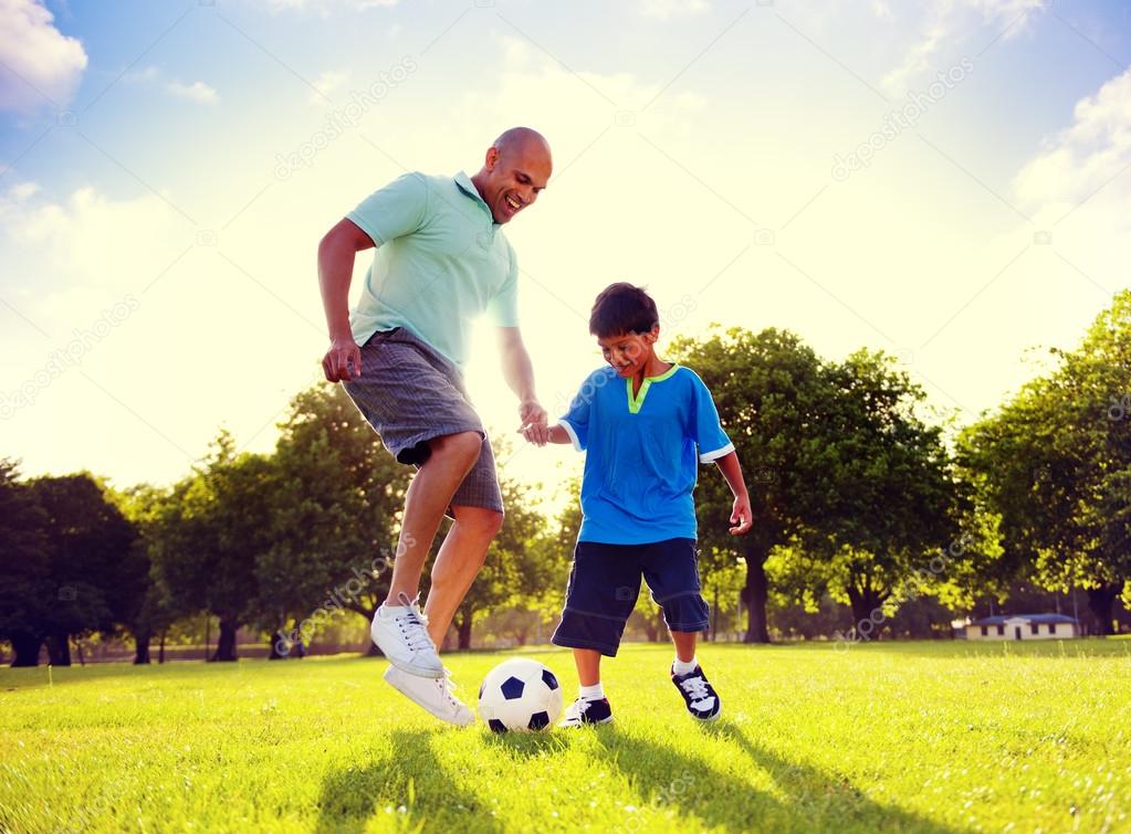 father playing football with little son