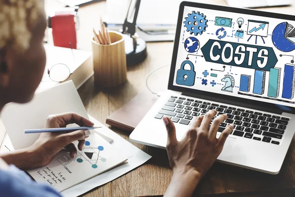 Woman working on laptop with costs — Stock Photo, Image