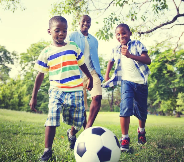 Father playing football with children — Stock Photo, Image