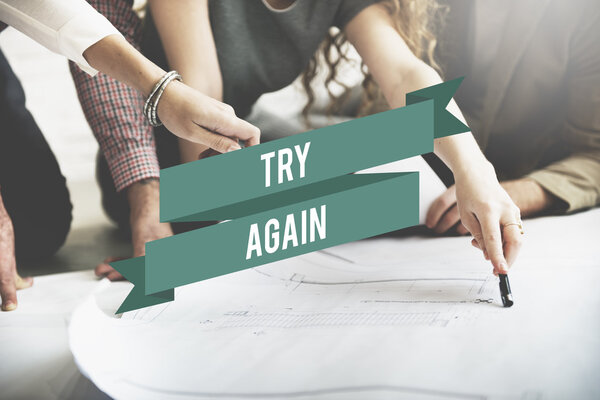 designers working with poster and try again