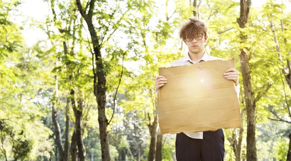 Businessman at outdoors holding cardboard — Stock Photo, Image