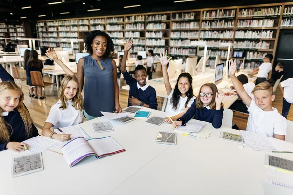 Classmates having lesson with teacher — Stockfoto