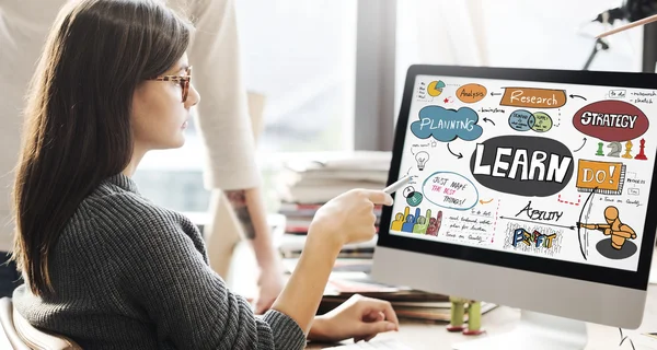 Woman showing on monitor with learn — Stock Photo, Image