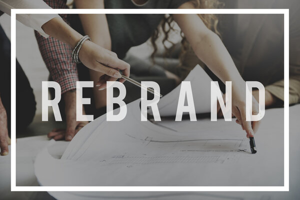 designers working with poster and rebrand