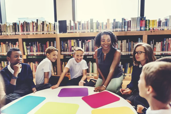 Classmates having lesson with teacher — Stock fotografie