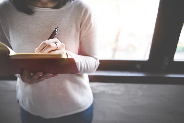 Asiatiska Lady Writing i anteckningsboken — Stockfoto