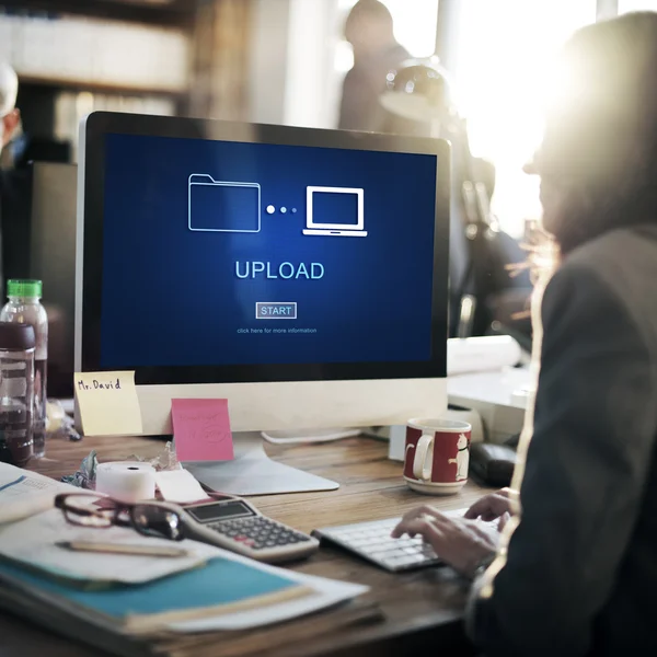 Businesswoman with upload on monitor — Stock Photo, Image