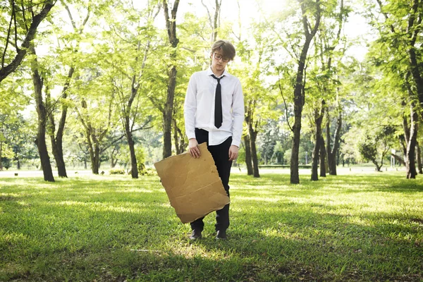 Businessman at outdoors holding cardboard — Stock Photo, Image