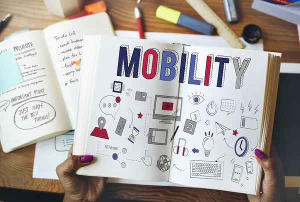 Woman holding book with mobility — Stock Photo, Image