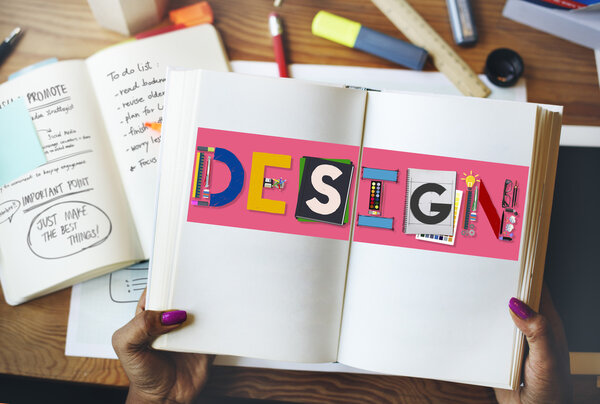 woman holding book with design