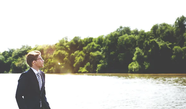 Businessman at outdoors near river — Stock Photo, Image