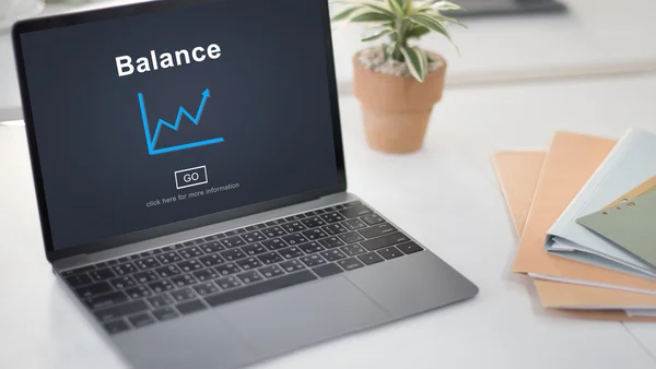 Laptop on table with balance — Stock Photo, Image