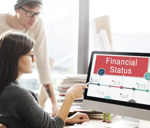 Woman showing on monitor with financial status — Stock Photo, Image