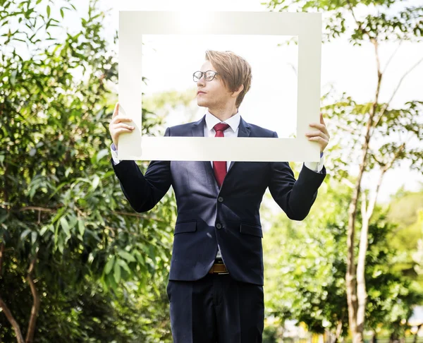 Empresário com moldura branca — Fotografia de Stock