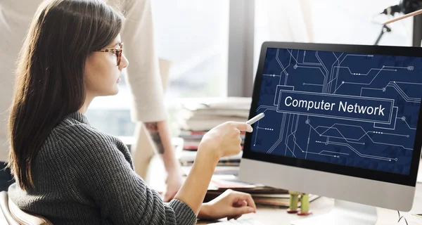 Frau zeigt mit Computernetzwerk auf Monitor — Stockfoto