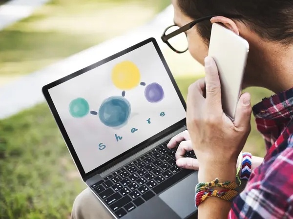 Man met behulp van digitale apparaten, surfen op het internet op laptop en spreken op de telefoon — Stockfoto