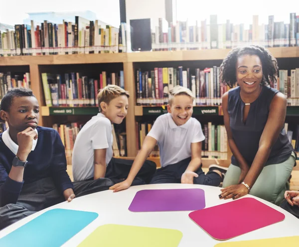 Group of children studying in library — Stock Photo, Image