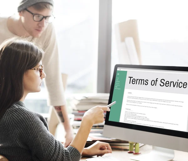 Woman showing on monitor with terms of service — Stock Photo, Image