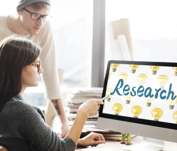 Woman showing on monitor with research — Stock Photo, Image