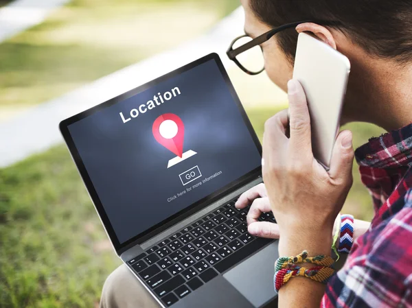 Man using digital devices, surfing the internet on laptop and speaking on the phone — Stock Photo, Image