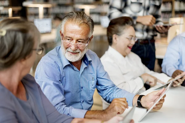 Mature students in library — Stock Photo, Image