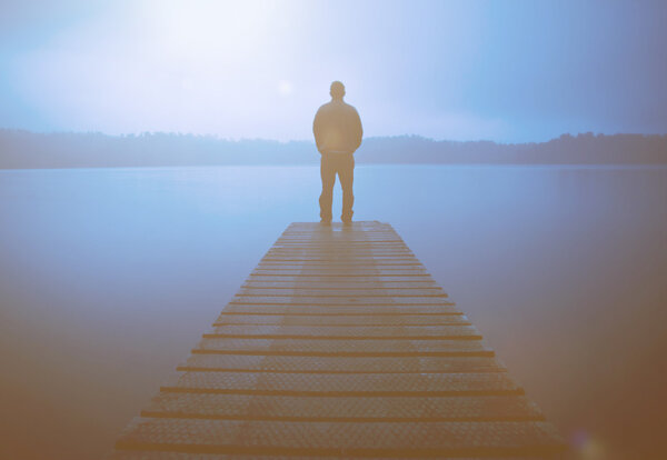 Man Standing on a Jetty