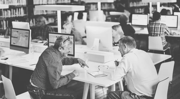 Pessoas usando o computador na biblioteca — Fotografia de Stock