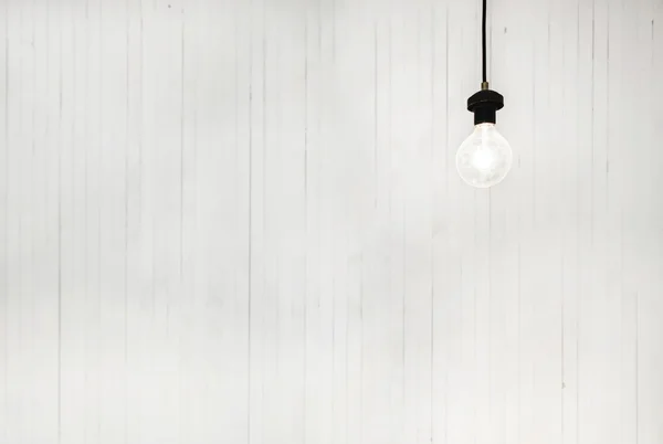 Light Bulb on White Wall — Stock Photo, Image