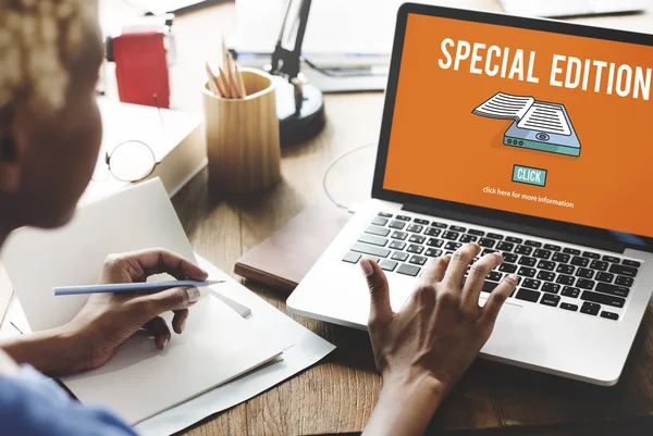 Woman working on laptop with special edition — Stock Photo, Image