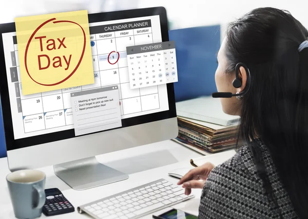 Businesswoman working on computer with Tax Day — Stock Photo, Image