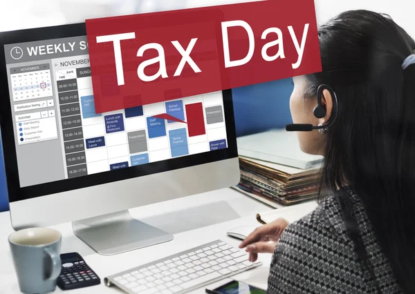 Businesswoman working on computer with Tax Day — Stock Photo, Image