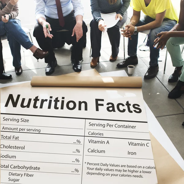 People over poster with Nutrition Facts — Stock Photo, Image