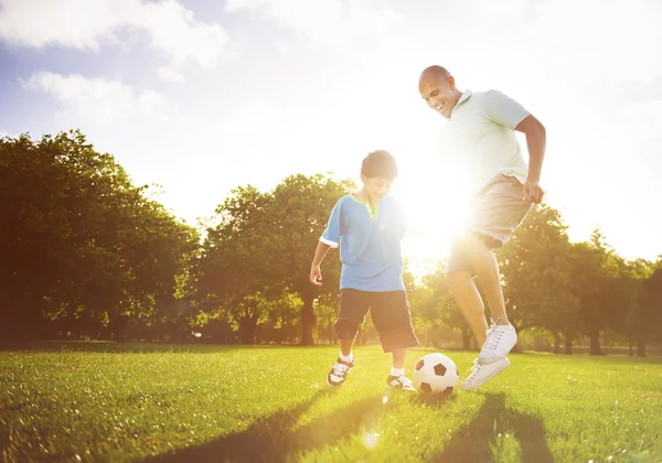 Father playing football with little son — Stockfoto