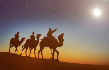 Men riding camels through desert   clipart
