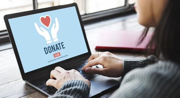 Woman typing on laptop with donate — Stock Photo, Image