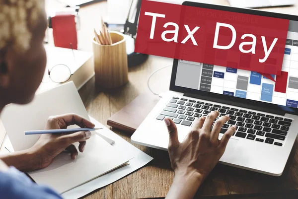 Woman working on laptop with tax day — Stock Photo, Image