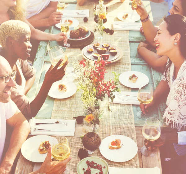 people sitting at table and celebrating