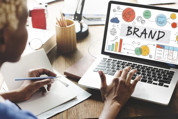 Woman working on laptop with brand — Stock Photo, Image