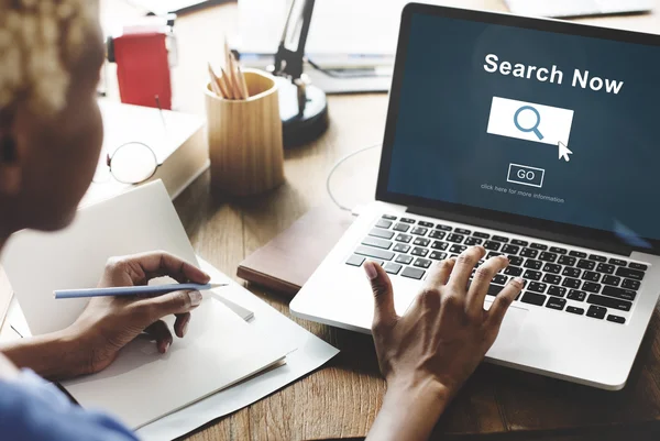 Woman working on laptop with Search Now — Stock Photo, Image