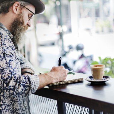 Sakallı adam kahve içiyor.