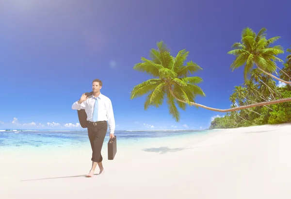 Businessman walking on beach — Stock Photo, Image