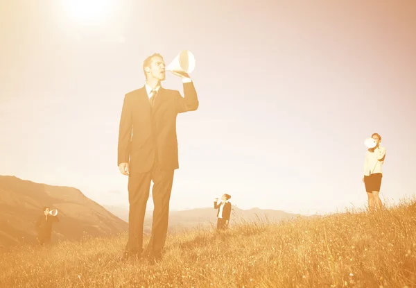 Business people in mountains — Stock Photo, Image