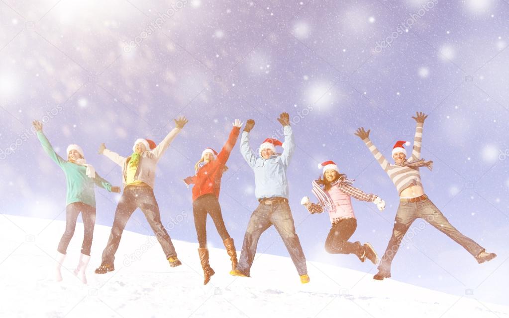 Friends jumping in snow