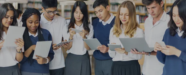 Estudiantes navegando gadgets digitales —  Fotos de Stock