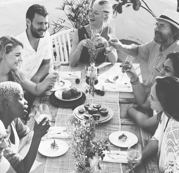 people sitting at table and celebrating