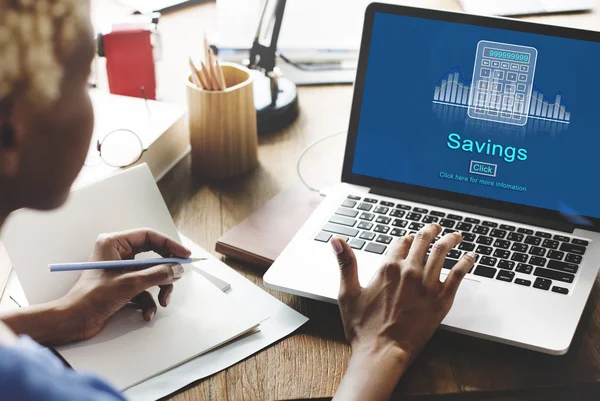 Woman working on laptop with saving — Stock Photo, Image