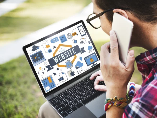 Young man with laptop and smartphone — Stock Photo, Image