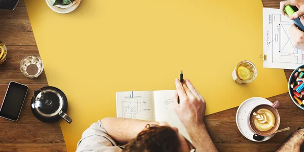 Table with yellow poster — Stock Photo, Image